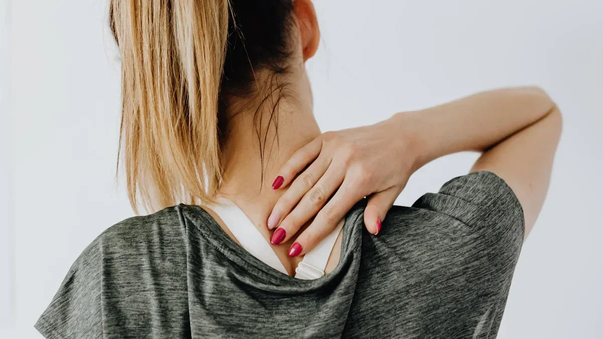 Woman massaging neck and shoulder pain, seeking relief from muscle tension or stiffness
